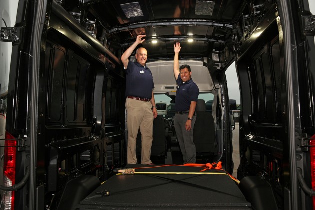 Ford officials show off the interior height of the high-roof van. Derek Bier, on the left, is 6'6". Photo by David Freers/Ford Motor Company.