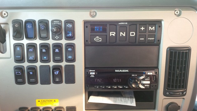 The mDrive console sits in the dash. Exposed screws provide easy access to the wiring behind.