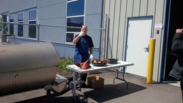Trison Tarps founder Paul Vandenberg gives the thumbs up after carving into the roasted pig.