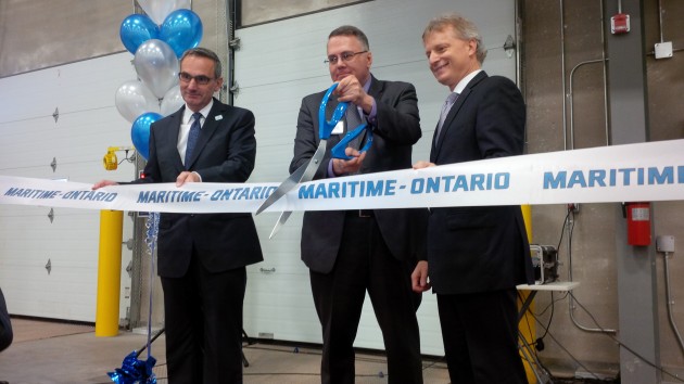Doug Munro, president and owner of M-O, cuts the ribbon.
