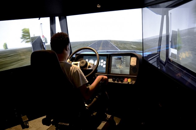 A Celadon Driving Academy student practices his driving skill on the TransSim(TM) VS6 driving simulator. This machine provides real world driving environments specifically designed for training commercial vehicle truck drivers. (PRNewsFoto/Celadon Trucking)