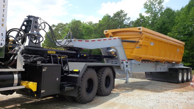 A side-dump trailer with integrated fifth wheel converts the MBT-40 into a tractor.