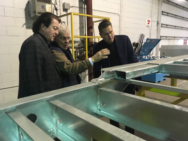Neil McKenna (left) discusses the concept with Canadian Tire colleagues.